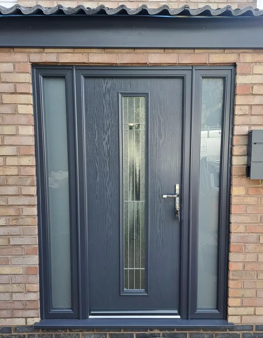 A dark grey composite door with a glazed side panel each side
