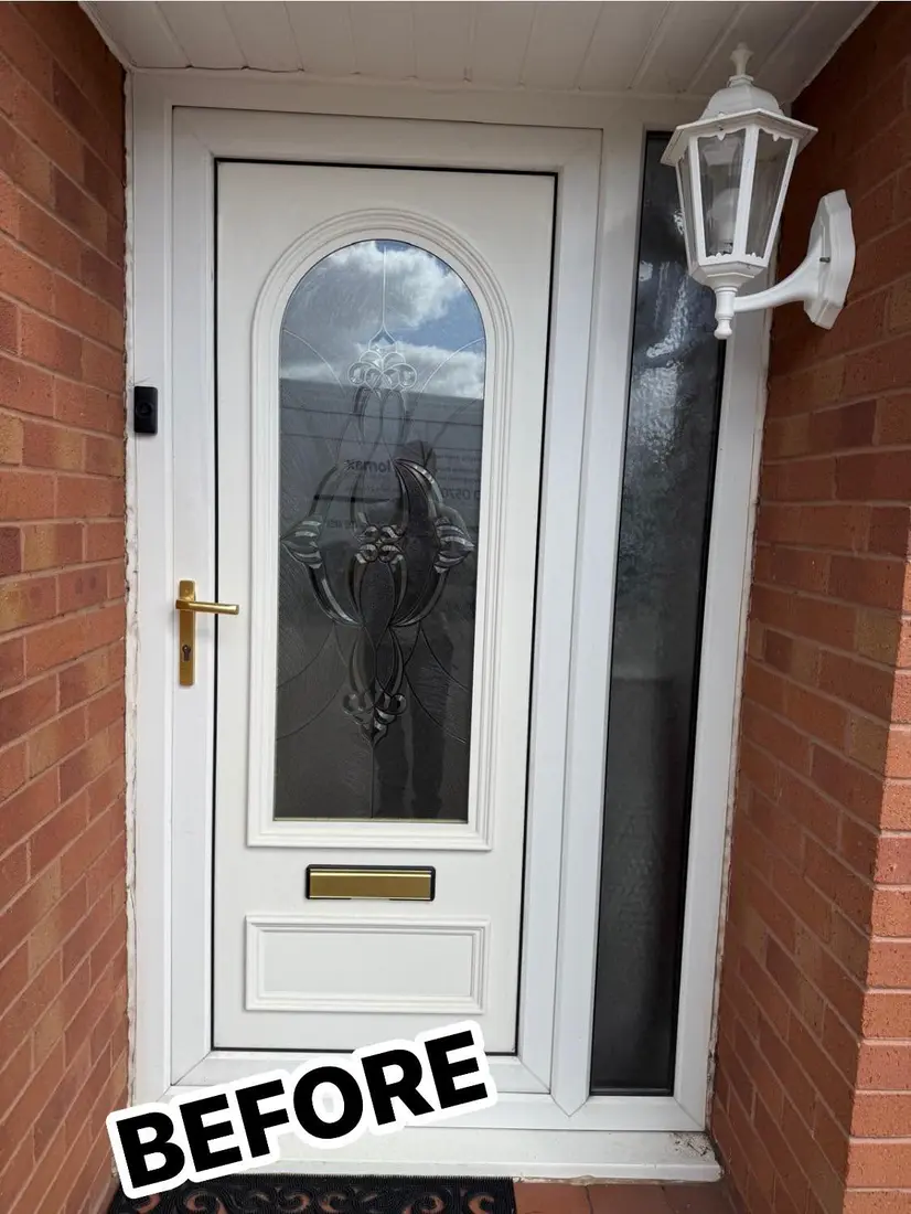 Before: An old white uPVC front door with an oval glass panel