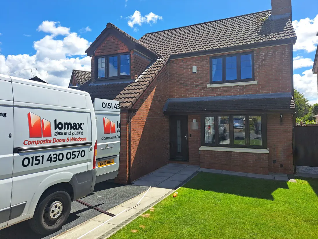 A Lomax van outside a brick house with new grey windows and front door